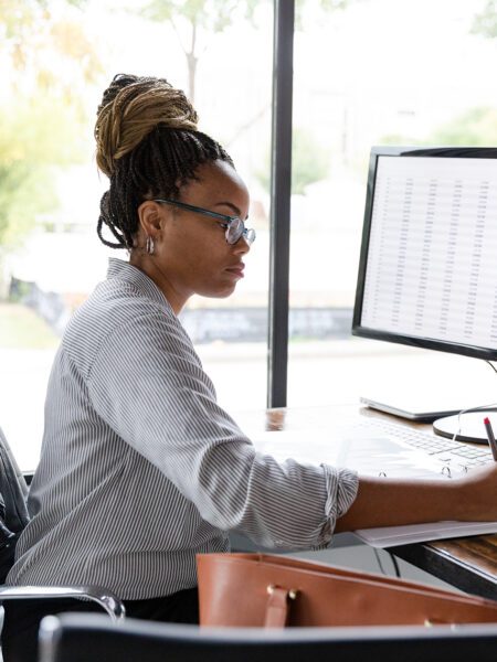 Busy businesswoman concentrates while working at her desk