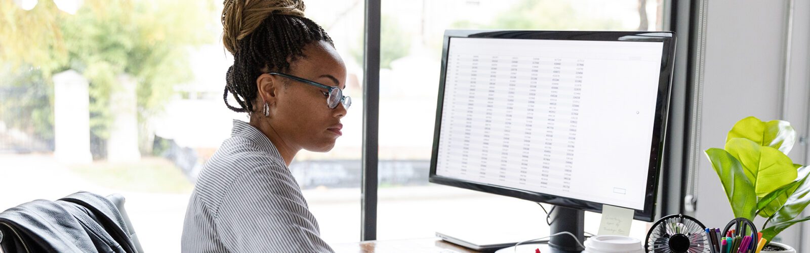 Busy businesswoman concentrates while working at her desk