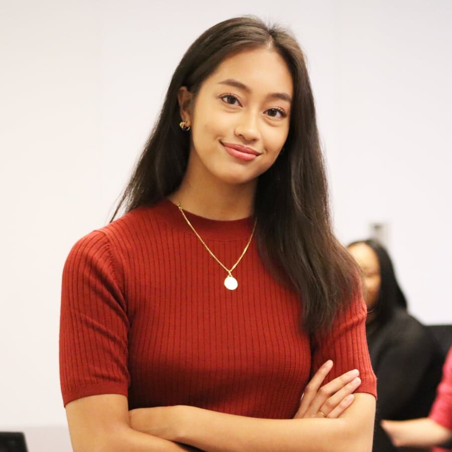 Smiling woman with crossed arms