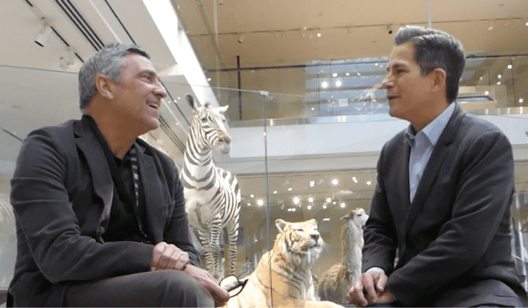 Two men sitting and having a conversation at the NHMLA.